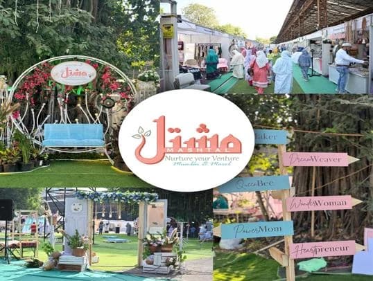 The Mashtal exhibition entrance with the flower swing, signposts and visitors between stalls